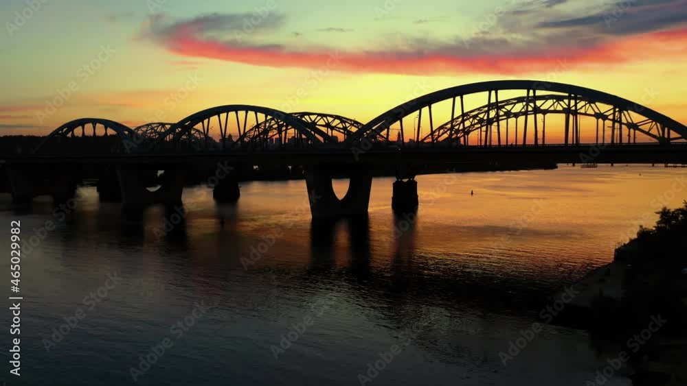 Drone view on the bridge above the river and city scape. Drone view on the bridge above the river and city scape.