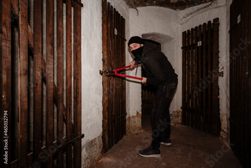 Thief trying to break into a basement