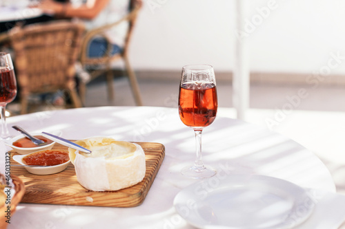 A glass of traditional Portuguese sweet wine moscatel with cheese and bread in a cafe photo