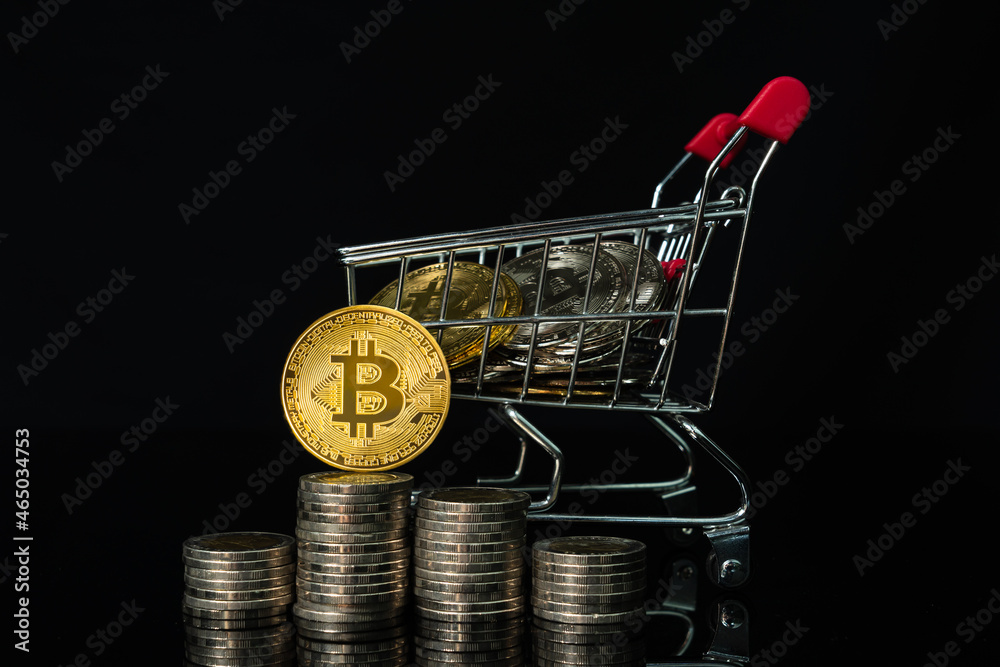 Bitcoin coin in shopping cart with black background