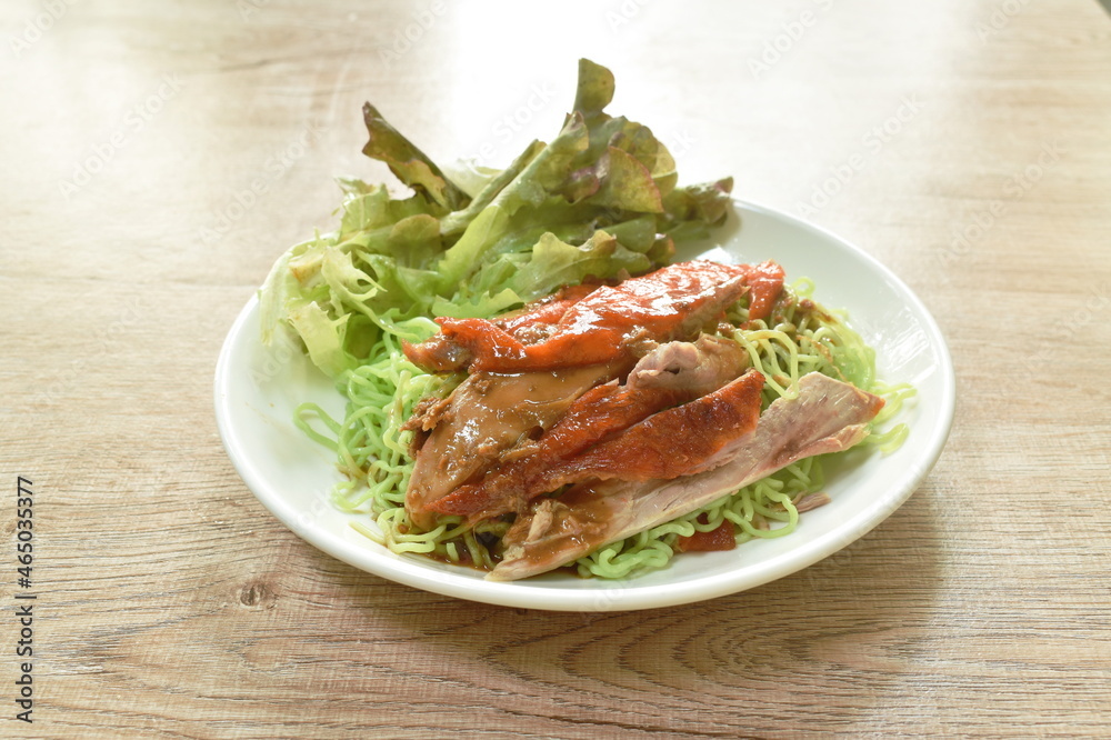 Chinese jade noodles topping slice rosted duck dressing sweet soy sauce on plate