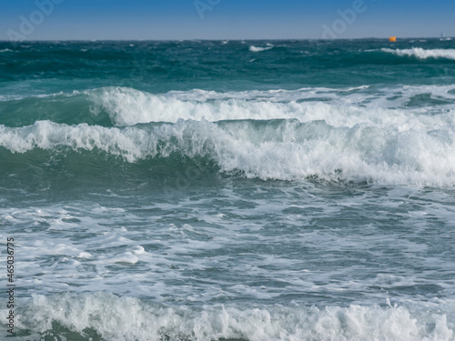 rough blue sea with waves with foam