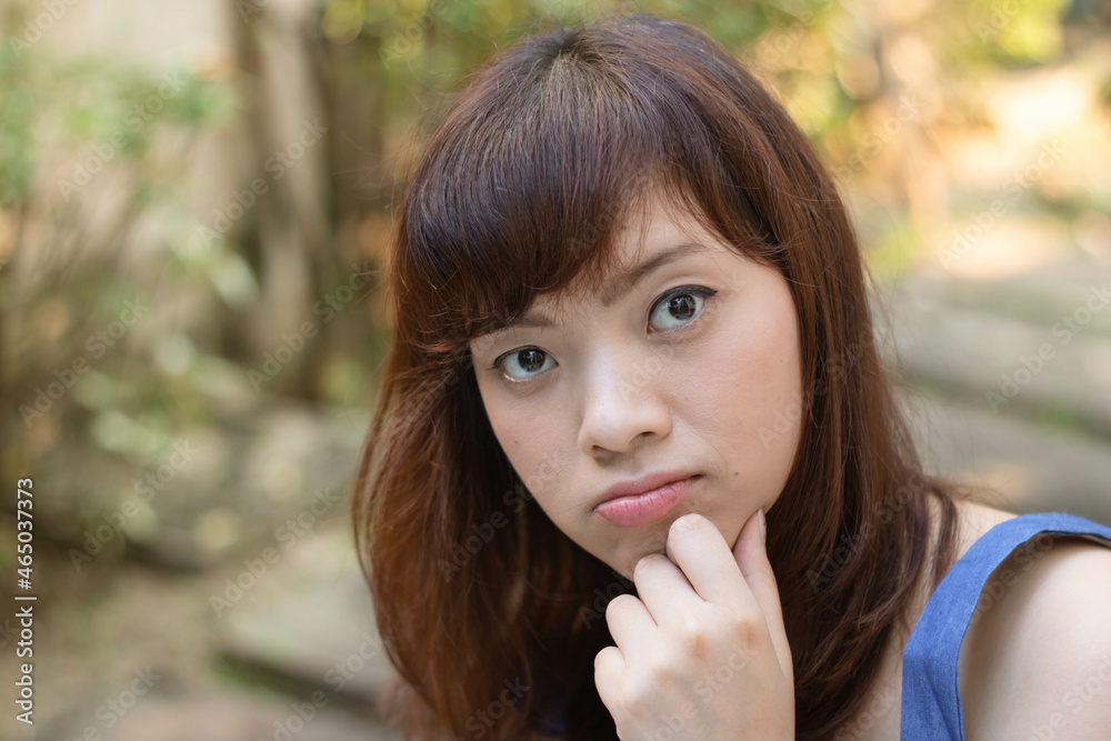 Close up of young pretty Asian woman in the garden. Close up of young pretty Asian woman in the garden.