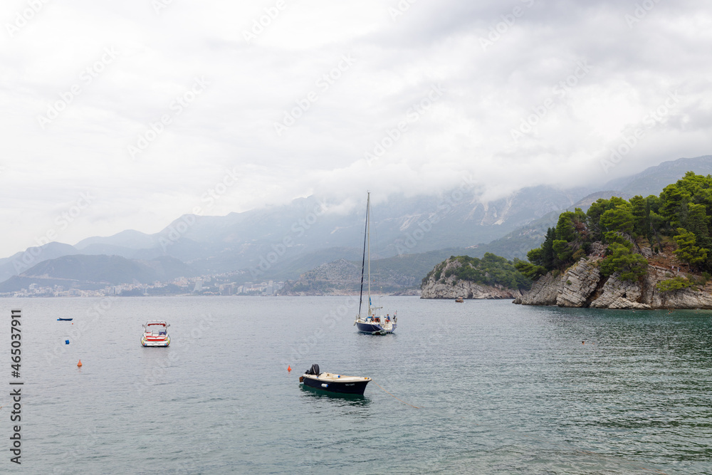Sveti Stefan, Montenegro- September 15, 2021: summer sunset with Beach (Montenegro, 6 kilometers southeast of Budva). luxury resort for reach people. Resort includes islet of Sveti Stefan and part Sveti Stefan, Montenegro- September 15, 2021: summer sunset with Beach (Montenegro, 6 kilometers southeast of Budva). luxury resort for reach people. Resort includes islet of Sveti Stefan and part