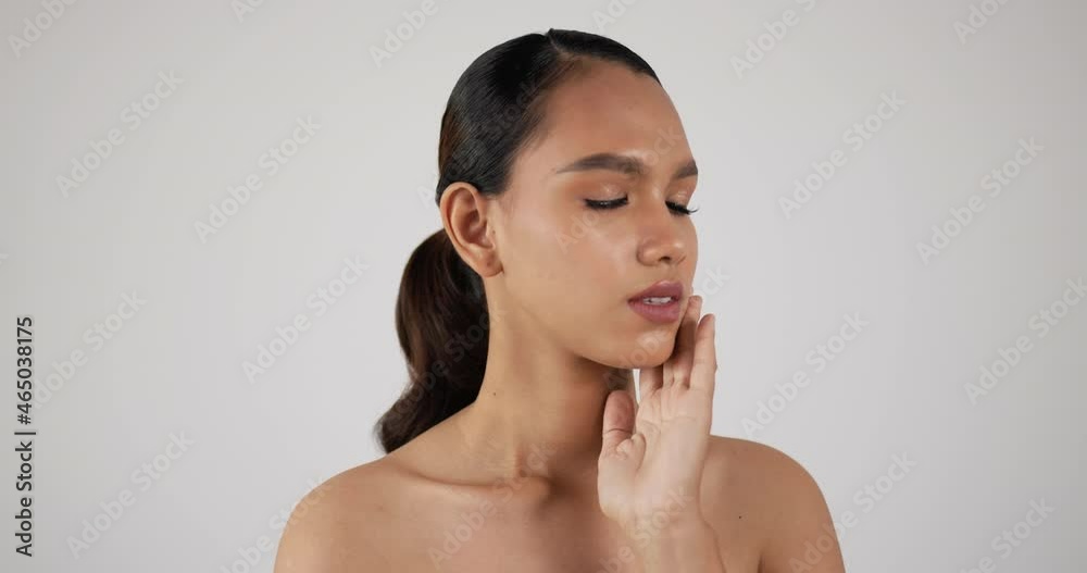 Happy attractive young woman touching pretty face after applying cream do make up Happy attractive young woman touching pretty face after applying cream do make up