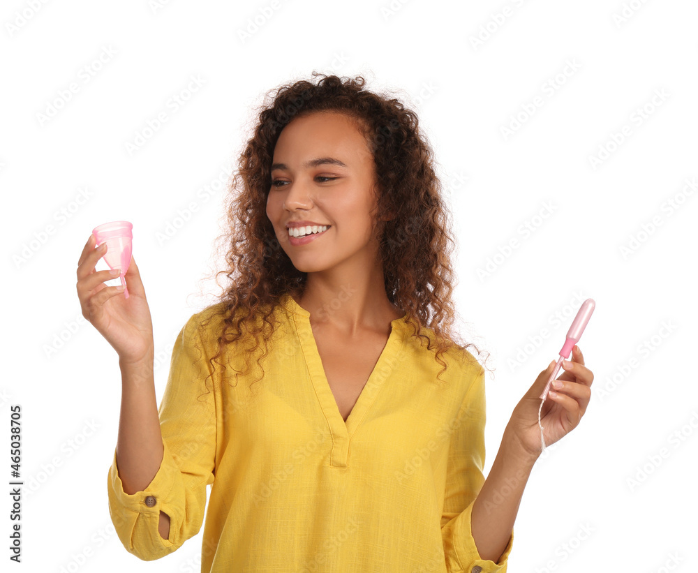 Young African American woman with menstrual cup and tampon on white background Young African American woman with menstrual cup and tampon on white background