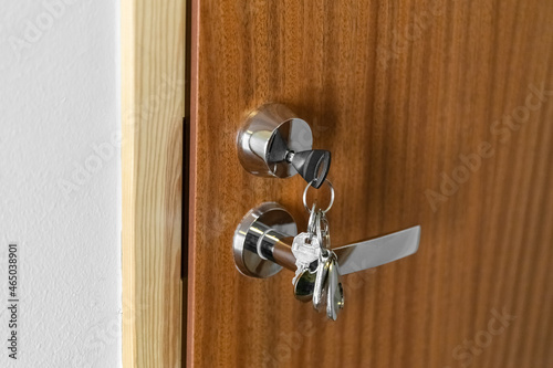 A bunch of keys in a door lock. The key is in the lock. Mortgage Concept. Photo photo