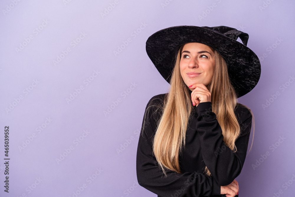 Young Russian woman disguised as a witch celebrating Halloween isolated on purple background looking sideways with doubtful and skeptical expression. Young Russian woman disguised as a witch celebrating Halloween isolated on purple background looking sideways with doubtful and skeptical expression.