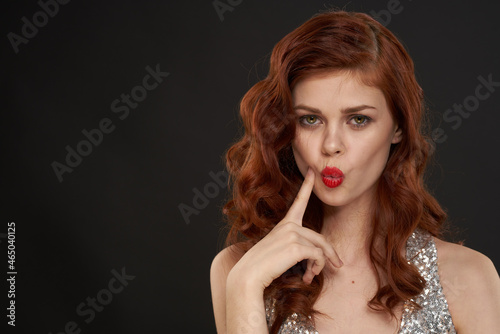 elegant woman in silver dress beautiful hairstyle posing dark background