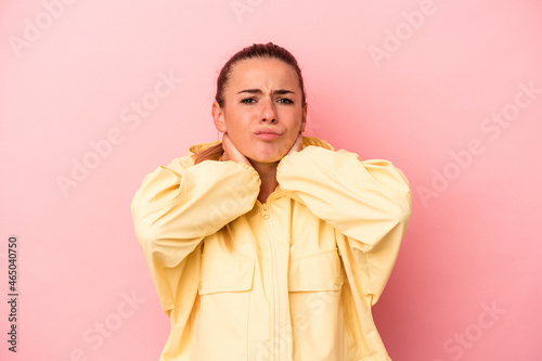 Young Russian woman isolated on pink background pointing with forefingers to a copy space, expressing excitement and desire. © Asier