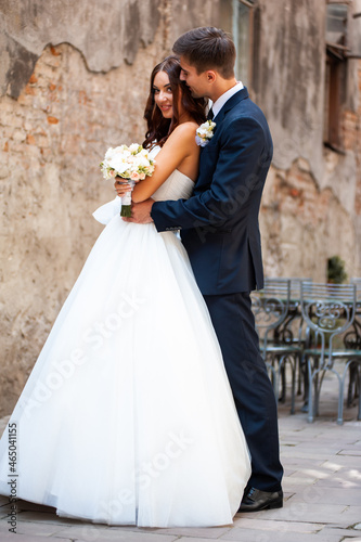 Happy newlywed bride and groom in the old city