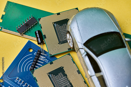 CPU chip and semiconductors with car toy. Global car chip shortage. Micro-chip shortage creates dearth of new cars. Computer chip shortage stalls car industry production