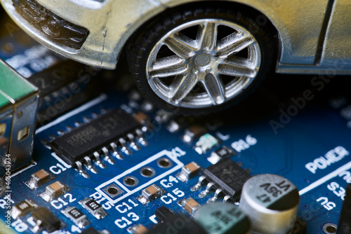 CPU chip and semiconductors with car toy. Global car chip shortage. Micro-chip shortage creates dearth of new cars. Computer chip shortage stalls car industry production