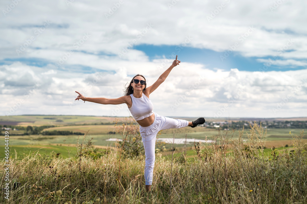 pretty girl enjoys a warm sunny summer day on a meadow with tall grass pretty girl enjoys a warm sunny summer day on a meadow with tall grass