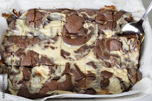 Freshly baked marbled chocolate brownies in an oven tray