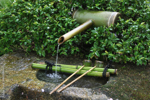 Traditional water spring with bamboo ladles in Japan. Temizu-ya is a Shinto water pavilion for a ceremonial purification rite known as temizu or chōzuya photo