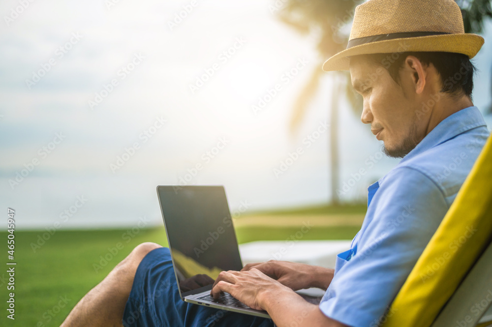 Man using laptop computer on beach sea and Man travel holiday Phuket island sandbox Thailand are freedom life financial Man using laptop computer on beach sea and Man travel holiday Phuket island sandbox Thailand are freedom life financial