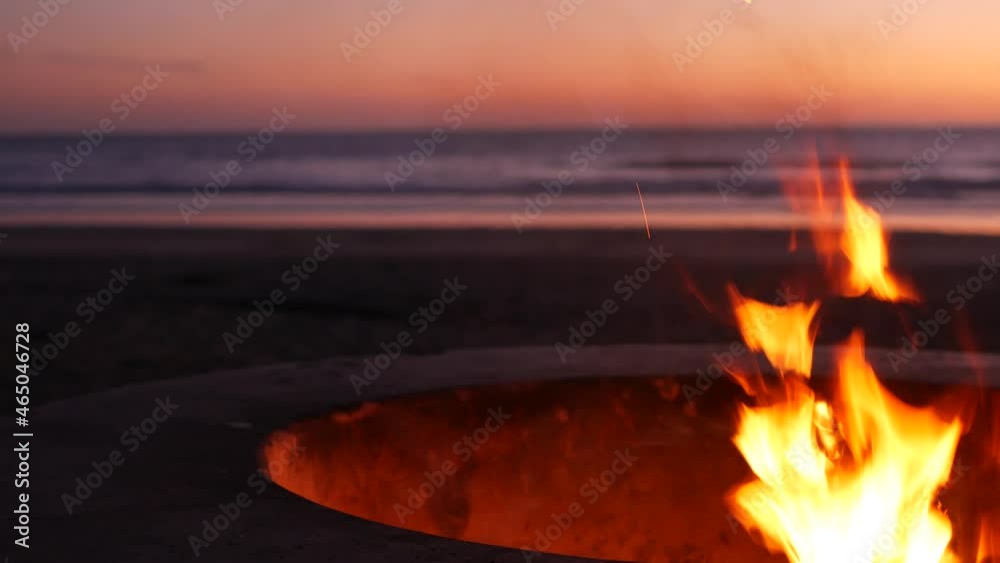 Campfire pit by Oceanside pier, California USA. Camp fire burning on