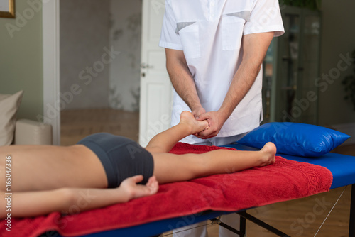 Wellness massage for children. Hands of the masseur close-up. Physiotherapist working with patient in clinic