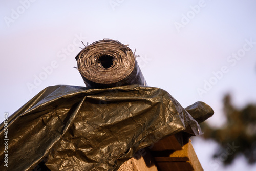 Selective focus photo. Plastic material on building site facade. photo