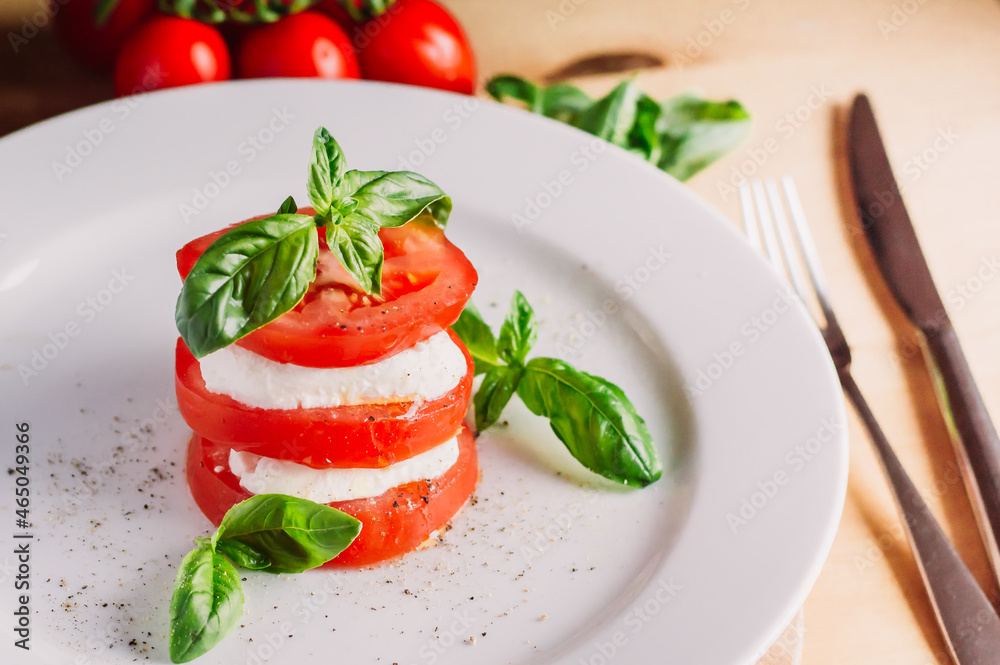 Caprese salad with mozarella cheese,tomatoes and basil.creative option Caprese salad with mozarella cheese,tomatoes and basil.creative option