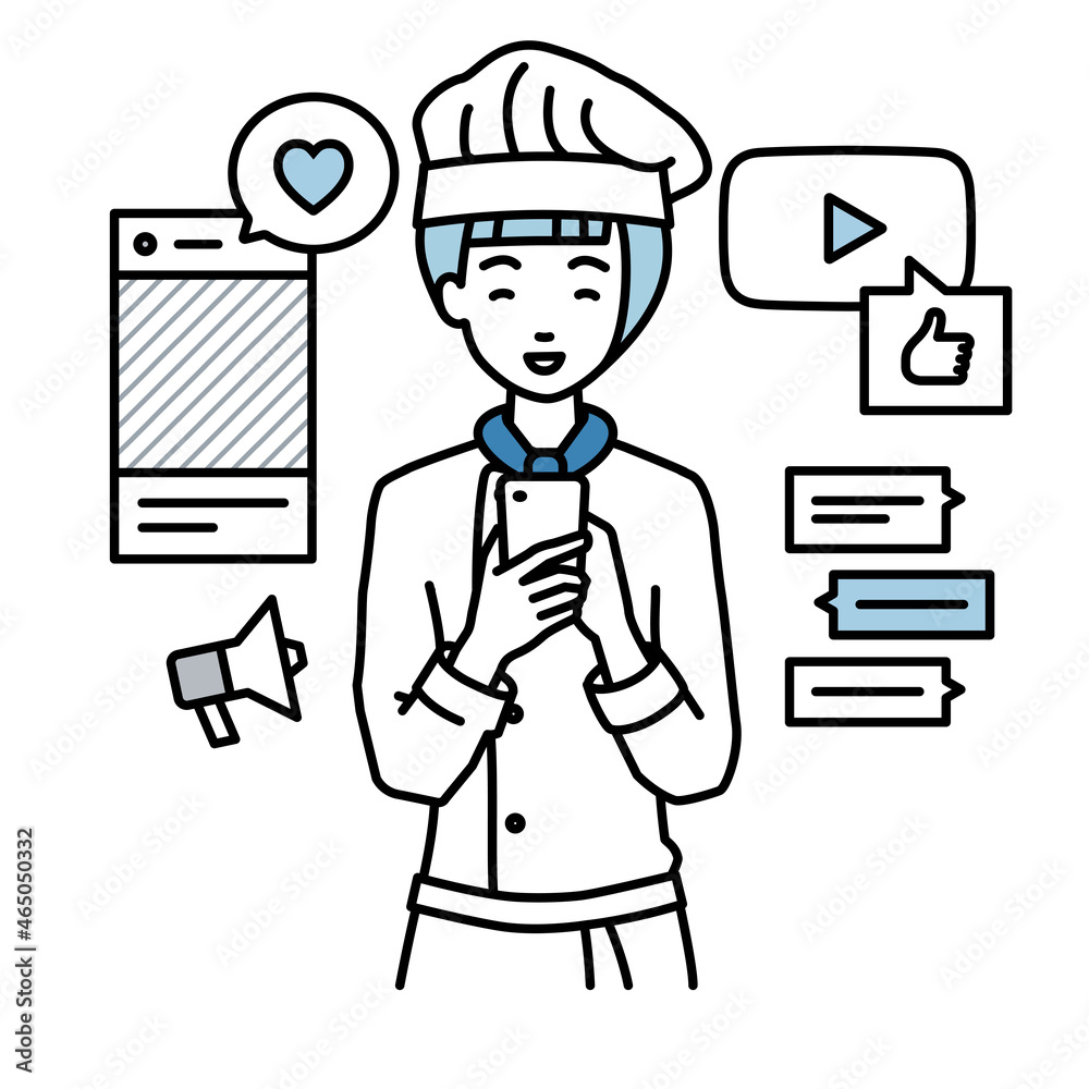 立ってスマートフォンでさまざまなSNSで楽しく交流する調理師の女性 立ってスマートフォンでさまざまなSNSで楽しく交流する調理師の女性