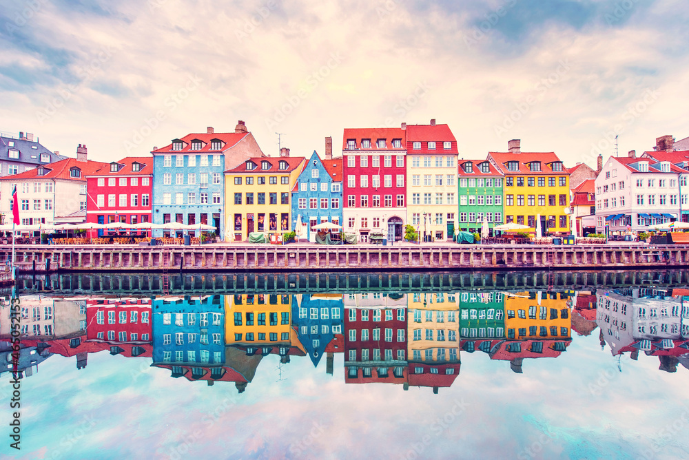 Breathtaking beautiful scenery with boats in the famous Nyhavn in Copenhagen, Denmark at sunrise. Exotic amazing places. Popular tourist atraction.