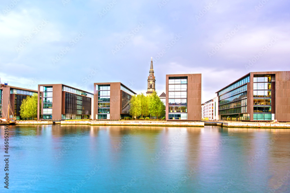 Breathtaking view with modern buildings and church spire on Copenhagen waterfront, Denmark. Exotic amazing places. Popular tourist atraction.