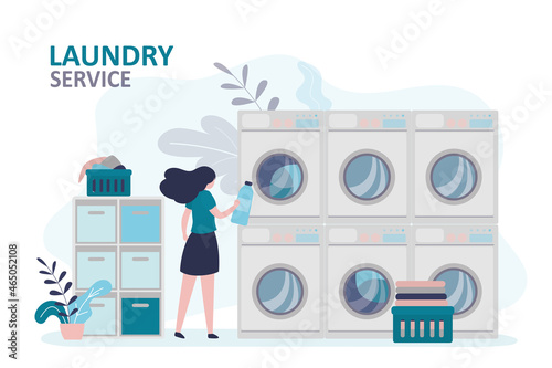 Girl pours powder or fabric softener into washer. Woman washing clothes in public laundry. Baskets of dirty and clean things