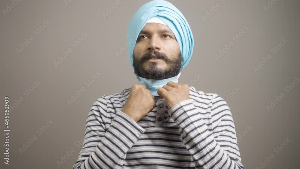 young Sikh man relaxing after removing medical face mask during coronavirus covid-19 pandmeic - concept of breathing problem, sweating and feeling tired young Sikh man relaxing after removing medical face mask during coronavirus covid-19 pandmeic - concept of breathing problem, sweating and feeling tired