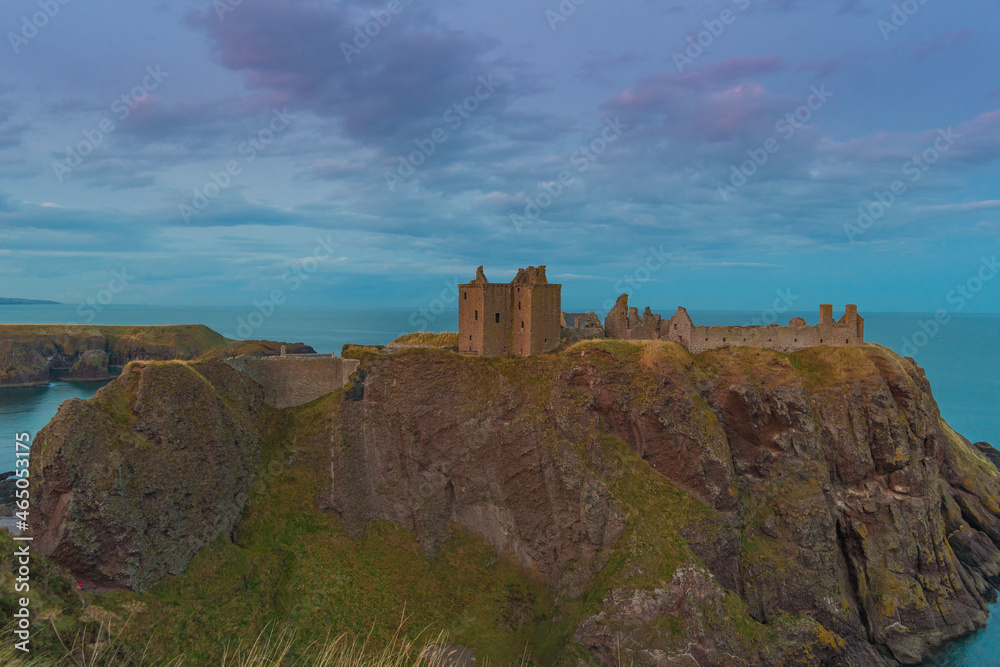 Dunnottar Castle is a ruined medieval fortress located upon a rocky headland on the north-eastern coast of Scotland south of Stonehaven. Sunset Evening Dunnottar Castle is a ruined medieval fortress located upon a rocky headland on the north-eastern coast of Scotland south of Stonehaven. Sunset Evening