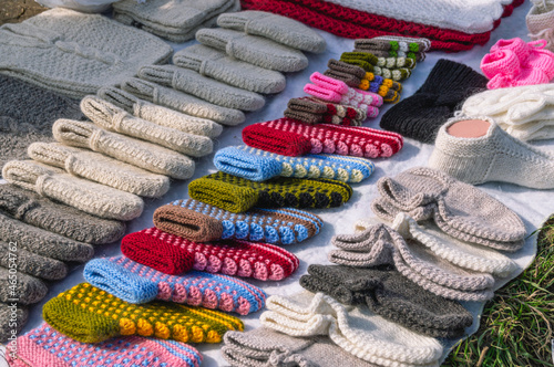 Handmade knitted products made of natural wool. Warm knitted things for winter. Knitted wool socks . The market of knitted things. Street market.