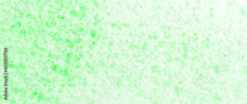 Drops of light green paint on watercolor paper. Abstract texture. Abstract background.