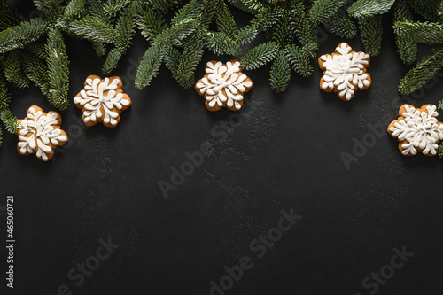 Fototapeta Naklejka Na Ścianę i Meble -  Christmas glazed cookies as snowflakes on black background. Happy New Year. View from above. Flat lay. Copy space