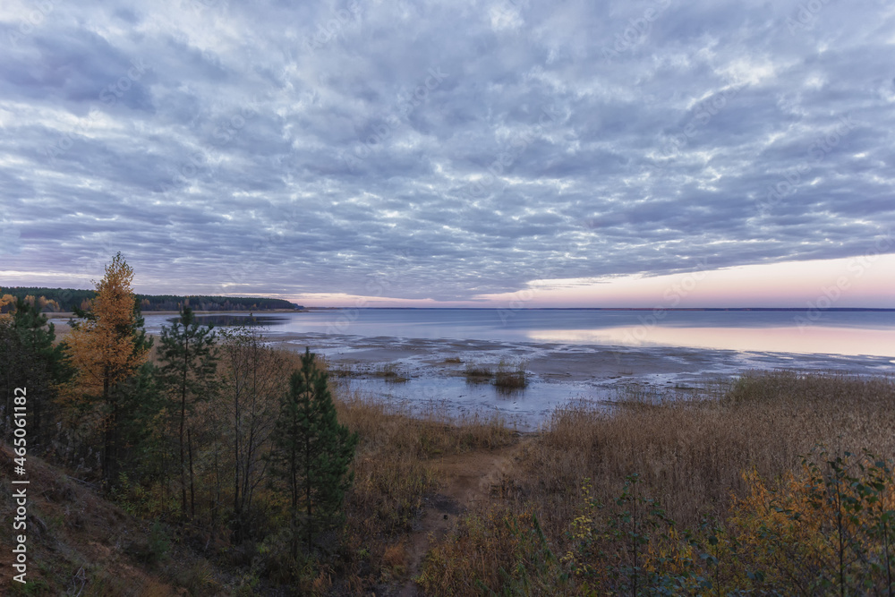 View of the Volga-Baltic reservoir. A wide beautiful river at sunset in the fall. View of the Volga-Baltic reservoir. A wide beautiful river at sunset in the fall.