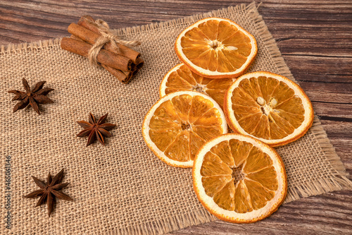 Dry orange oranges. Dried citrus fruits. Tropical fruit. On a brown background.
