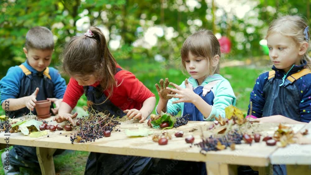 forest kindergarten Happy Preschool or school group children play Cook in swamp improvised kitchen. Outdoors small child have fun playing. Summer Camp, kid leisure educational entertainment in nature