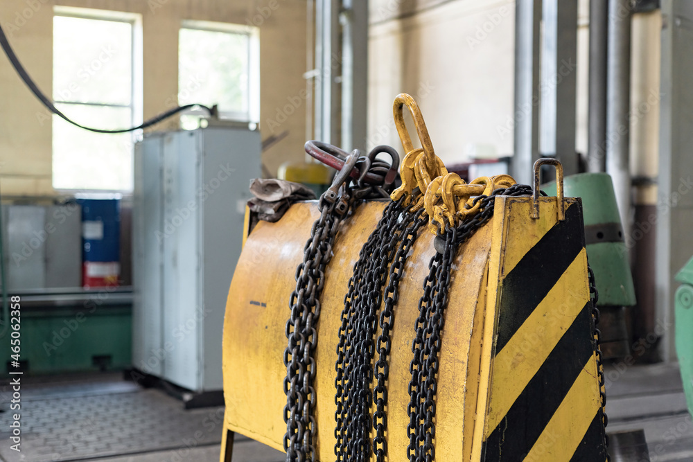 Yellow storage rack for chain slings for lifting loads on a crane ...