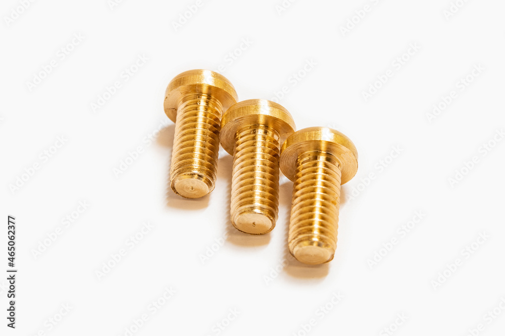 Bronze screws made on a lathe on a white isolated background. Bronze screws made on a lathe on a white isolated background.