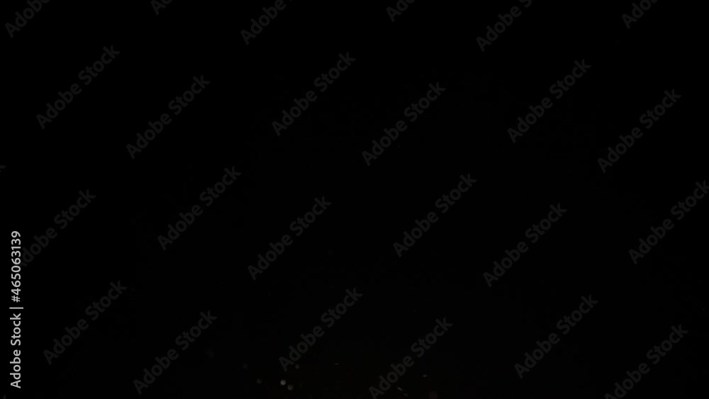 flying chips infront of black background in slowmotion