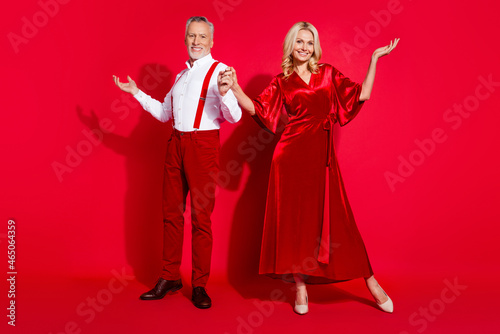 Full body photo of mature grandmother grandfather partners disco xmas event noel atmosphere isolated over red color background