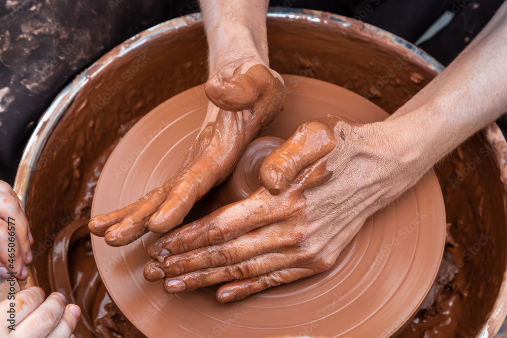 Master class on modeling of clay on a potter's wheel In the pottery workshop Master class on modeling of clay on a potter's wheel In the pottery workshop