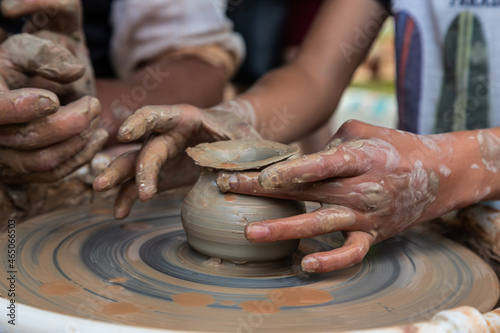 Master class on modeling of clay on a potter's wheel In the pottery workshop