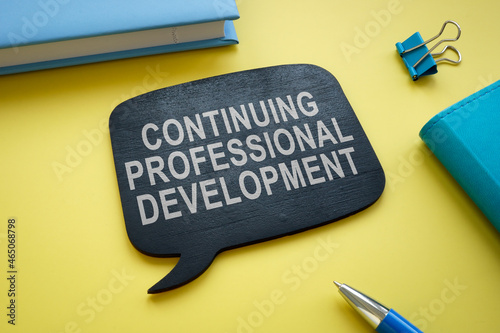 Continuing professional development memo on the yellow desk. photo