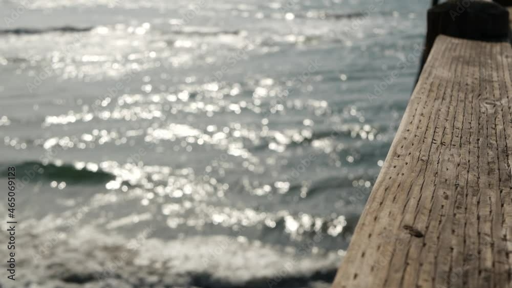 Railings of old wooden pier, waterfront boardwalk, Oceanside beach atmosphere, California coast USA. Defocused seascape, pacific ocean water waves. Los Angeles vibes, summertime vacations aesthetic. Railings of old wooden pier, waterfront boardwalk, Oceanside beach atmosphere, California coast USA. Defocused seascape, pacific ocean water waves. Los Angeles vibes, summertime vacations aesthetic.