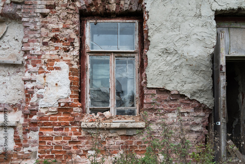 Old brick wall in an abandoned building. Doorway. Broken window