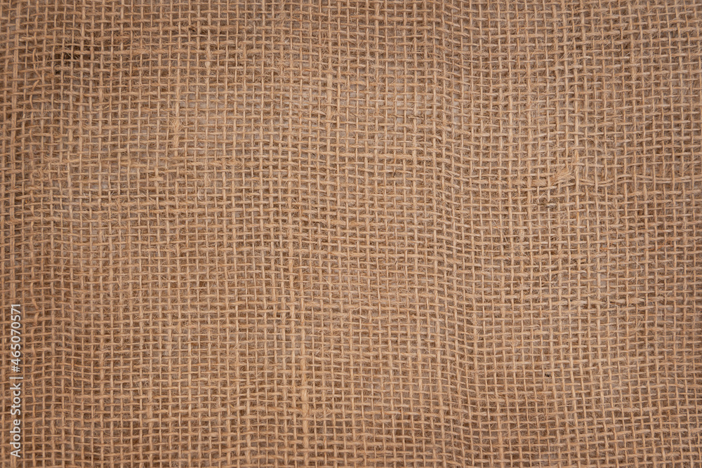 Background made of natural fabric burlap with square cells Background made of natural fabric burlap with square cells