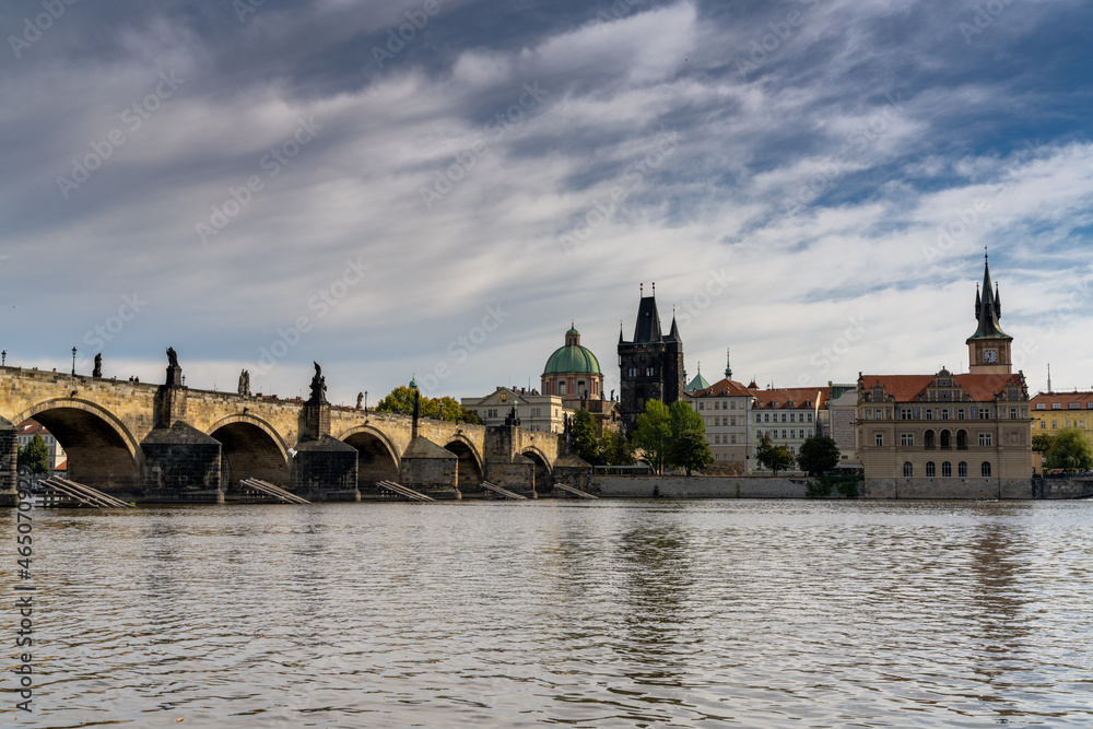 view of the Charles Bridge and the Vltava River in downtown Prague in autumn