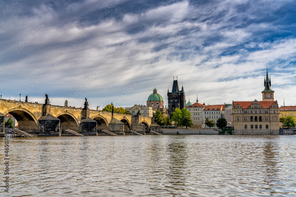 view of the Charles Bridge and the Vltava River in downtown Prague in autumn
