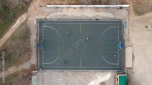 Top view of a basketball court during an outdoor game. Players on the court, on the court